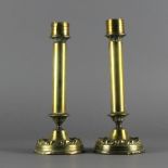 A pair of unusual late 19th Century brass pillar candlesticks of Arts and Crafts design, 24cm high