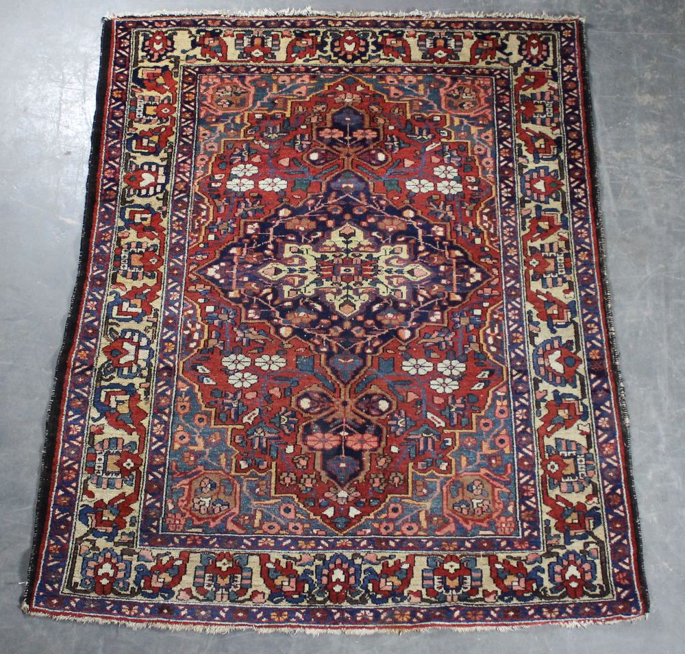 A Persian Bakhtiari rug. 194cm x 153cm. Some wear mainly to ends.