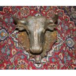 A cast-iron bulls head door ornament, mounted to wooden shield. 36cm high. Some corrosion but