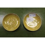 A pair of Chinese buff coloured 'anhua' decorated dragon design pin dishes