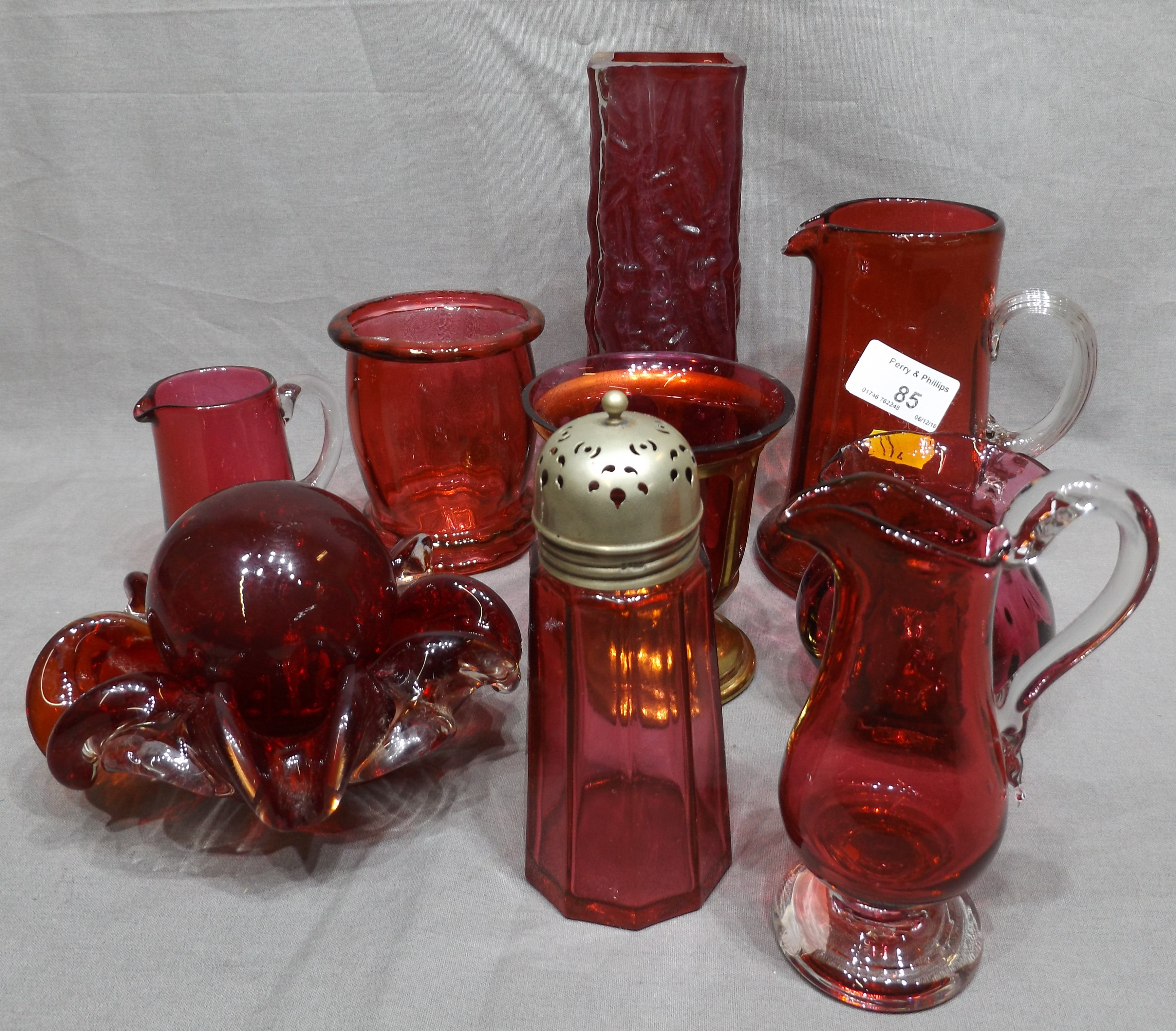 Ten Pieces of Cranberry Glass including Sugar Sifter, Vases, Jugs etc