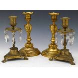 Pair of French cast ormolu candlesticks, 19th century, moulded with scrolls (lead weighted),