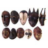 Ten African masks carved in various tribal styles, the largest measures 36cm high All lots in this