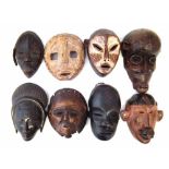 Eight African masks carved in various tribal styles, the largest measures 31cm high All lots in this