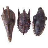 Two Guro - Yaure masks and a Warka metal mounted mask, the largest measures 41cm high All lots in