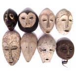 Eight African masks carved in various tribal styles, the largest measures 34cm high All lots in this