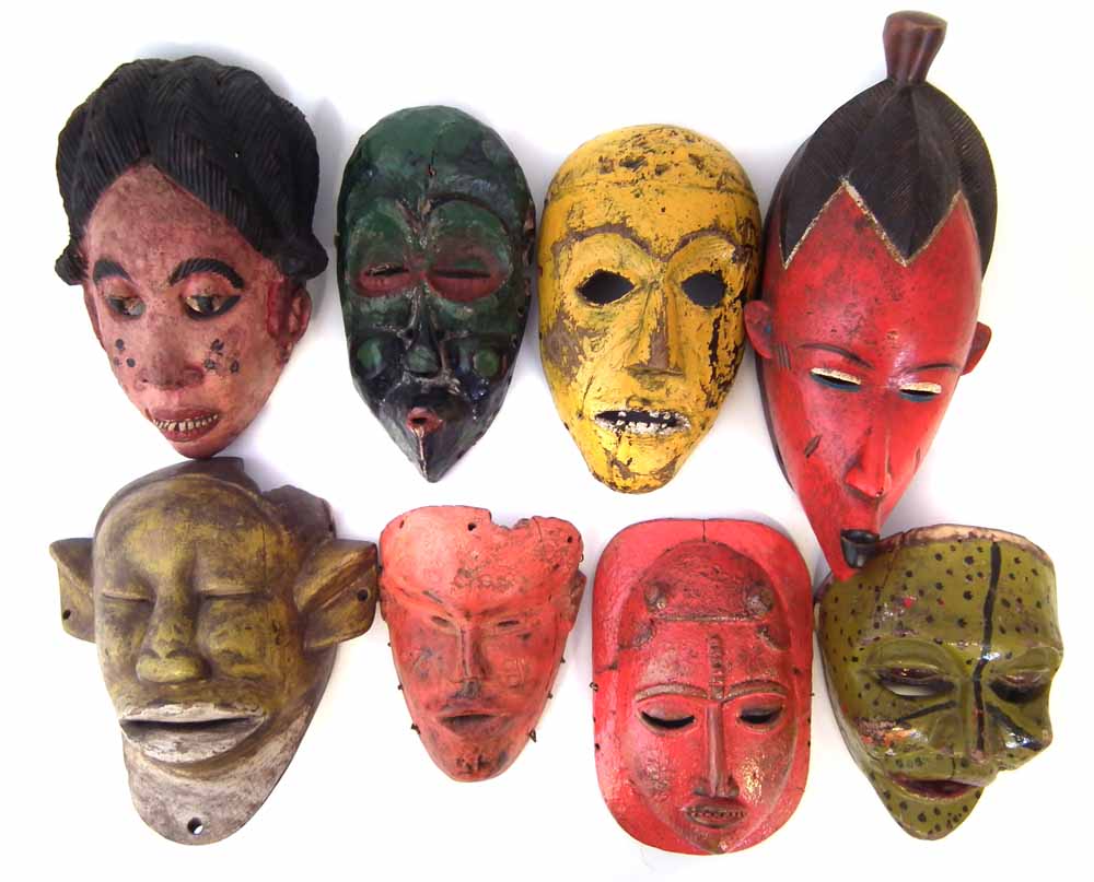 Eight painted African masks carved in various tribal styles, the largest measures 37cm high All lots