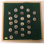 Framed collection of British Armed Forces badges with pearl backs and sterling silver rims.