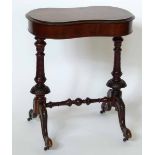 Victorian sewing table, the shaped top on turned end supports.