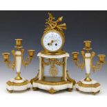 French gilt metal and alabaster clock garniture, the drumhead case with an enamel dial named