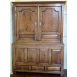 Oak livery cupboard, mid 18th century, of raised and shaped panels, width 138cm.