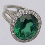 Green stone and diamond oval cluster ring, the white gold shank set with melee diamonds, ring size