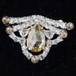 Platinum and diamond fancy triangular shaped brooch, central pear shaped rose cut cognac coloured