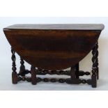 Oak oval gateleg table on barley twist legs and stretchers, length 122cm.