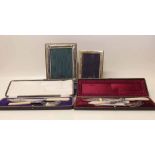 Two silver mounted photograph frames and two cased pairs of EP fish servers (4) Condition report: