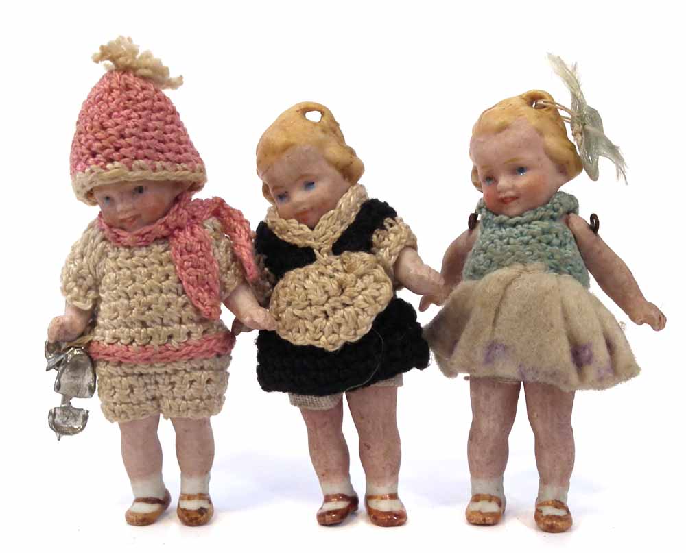 Hertwig bisque Skater doll, together with two other similar dolls, with porcelain jointed legs and