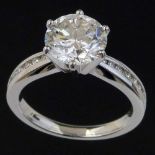 2.47ct brilliant cut diamond, colour I, clarity VS2, on channel set diamond shoulders in 750 white