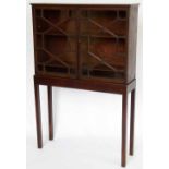 Mahogany bookcase or cabinet on stand of two astragal doors, width 84cm