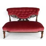 Victorian carved walnut lady's seat upholstered in pink velvet, width 105cm.