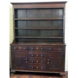 Oak and pine dresser, 19th century, the boarded back over nine drawers and two doors, length 156cm