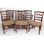 Set of six mahogany wavy ladder back dining chairs, including a carver, with stuffed over seats.