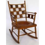 Oak Aesthetic Movement rocking chair, set alternately with carved panels on a leather seat with