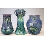 Three Minton Secessionist ware vases, tube lined with stylised foliate patterns on a purple