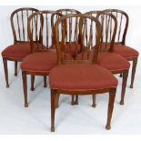 Six mahogany hoop and spindle backed dining chairs with stuffed over seats.