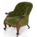 Victorian rosewood easy chair upholstered in buttoned green velvet, on French cabriole legs.