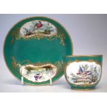 Sevres cup and saucer, painted with exotic birds within gilded cartouches on a green ground, painted