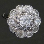 Diamond floret cluster ring, circa 1920, the central old cut stone ≈0.7ct, surrounded by ten