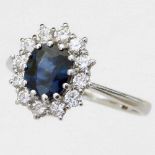 Sapphire and diamond oval cluster ring, the central stone ≈1.5ct, set in unmarked white gold,
