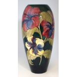 Moorcroft vase, decorated with Hibiscus pattern on a green ground, 35cm high Condition report: No