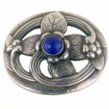 Georg Jensen oval silver brooch, pattern 138, of a stylised flower set with a lapis lazuli