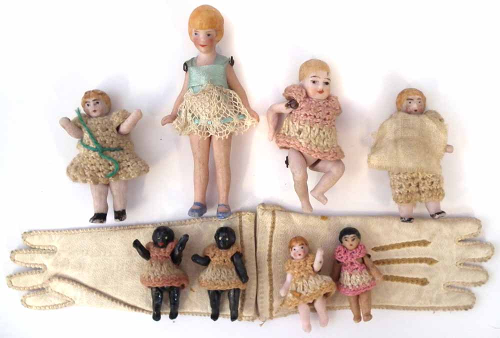 Eight miniature bisque dolls Hertwig or Carl Horn, with jointed legs and arms, also a pair of