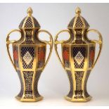 Pair of Caverswall twin handled vases and covers, the hexagonal bodies decorated with imari 'Romany'