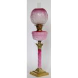 Corinthian column table oil lamp, the twist opaque pink glass stem and reservoir under a frosted