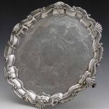 Silver salver with a shell and scroll rim and engraved field, Thos Bradbury, London 1900, diameter