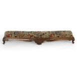 Victorian walnut long footstool upholstered in floral moquette, length 125cm.