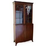 Mahogany bookcase, the glazed upper part over two doors on splayed bracket feet, width 100cm