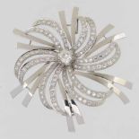 Platinum and diamond flower head brooch of an old brilliant cut central stone and radiating small