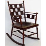 Aesthetic Movement mahogany rocking chair, impressed B38, the back and sides set alternately with
