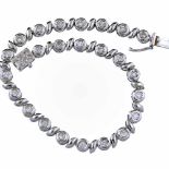 French 18ct white gold and diamond tennis bracelet of alternate circular and ogee links, length