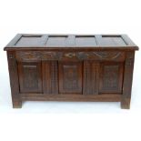 Oak coffer, the panelled top over carved front panels, length 129cm.