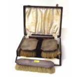 Cased pair of military silver backed brushes and comb, also a similar cloth brush. Condition report: