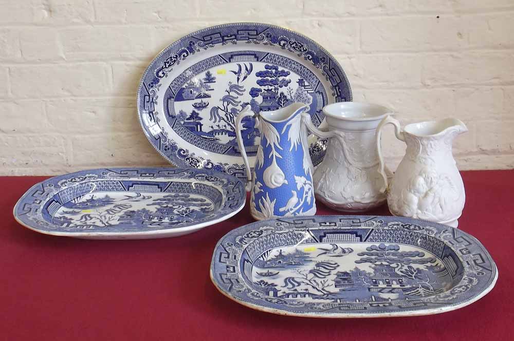 3 19th Century blue and white willow pattern meat platters and 3 Victorian slip ware jugs. Condition