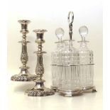 Pair of plated candlesticks and three bottle decanter set in a plated stand (lacking a stopper).