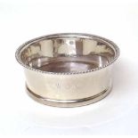 Silver coaster with turned wooden base. Condition report: see terms and conditions