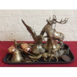 Brass eagle and red stag ornaments, qty of horse brasses and 2 brass bells, copper brandy and rum