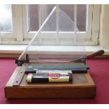 Office guillotine with guard, P.I.C engine divided slide rule, Armstrong (A.W. Faber) scale ruler,
